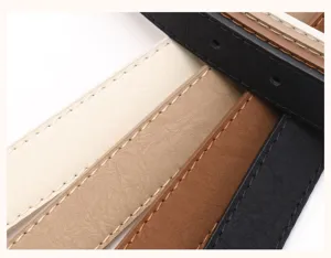 Macro detail of textured leather belts in assorted neutral colors with fine stitching