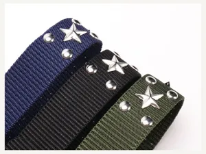 Macro detail view of three nylon belts featuring silver metal star studs and rivets.