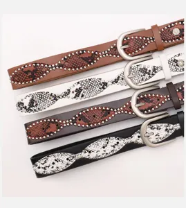 Detail of studded belts featuring snakeskin patterns and silver pin buckles in four colors