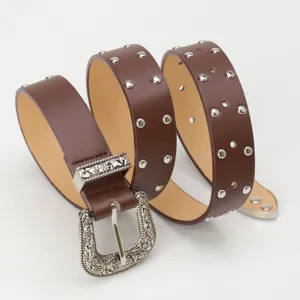Retro brown studded leather belt for women featuring an ornate engraved metal buckle