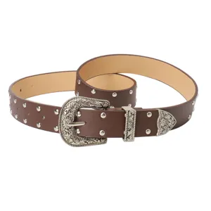 Vintage brown leather belt with silver studs and an engraved Western buckle for jeans.