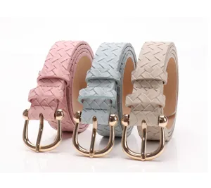 Close-up of three braided women's belts in pink, blue, and beige with gold horseshoe buckles.