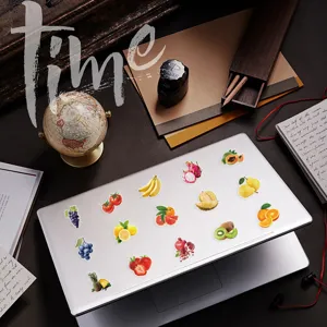 Vista dettagliata di adesivi colorati in PET alla frutta applicati su un laptop d'argento
