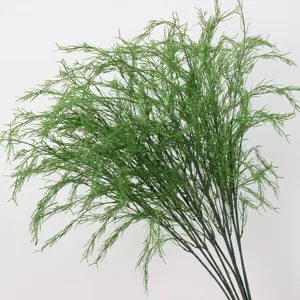 Detailed view of realistic artificial green asparagus grass branches for decor