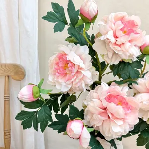 Close-up of pink and white artificial peony flower with realistic silk fabric petals