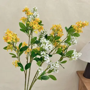 Detailed view of yellow and white artificial lilac flowers in a home interior setting