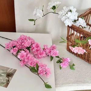 Detailed macro shot of realistic pink artificial cherry blossom branches for home decor