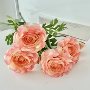 Close-up detail of realistic peach Ranunculus artificial flowers for home and wedding decor