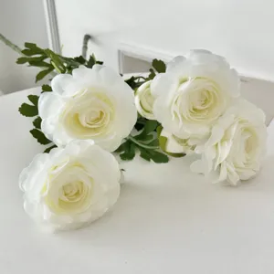 Detailed macro view of realistic white artificial ranunculus flowers for home decor