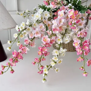 Detailed macro shot of pink and white silk delphinium flowers in a woven basket