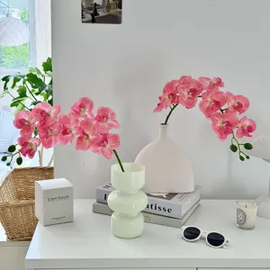 Detailed view of 70cm pink 9-head artificial orchid flowers in a modern home setting