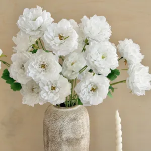 Elegant white artificial silk peonies in speckled ceramic vase for home table decoration