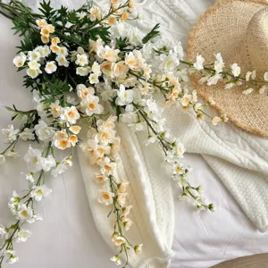 Detailed view of 3-fork artificial Delphinium flowers on soft white knit