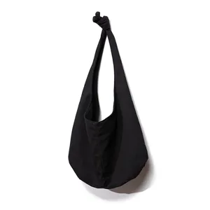 Bolso hobo minimalista de lona negra para mujer con elegante correa de hombro anudada