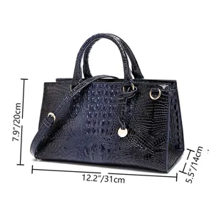 Vista detallada de un bolso retro de cuero grabado azul oscuro con dimensiones exactas.