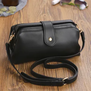 Classic retro black leather doctor bag featuring gold metal clasp and adjustable strap