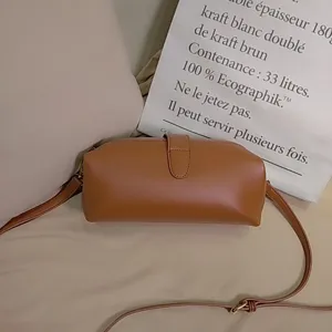 Detail of retro brown leather doctor bag with metal clasp and thin strap