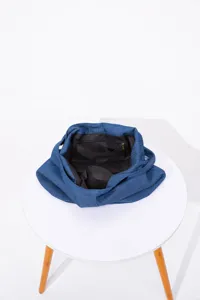 Vista interior detallada de bolso de lona azul con forro negro y bolsillo con cierre