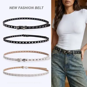 American retro punk style skinny belt for women with full eyelets on white and denim jeans