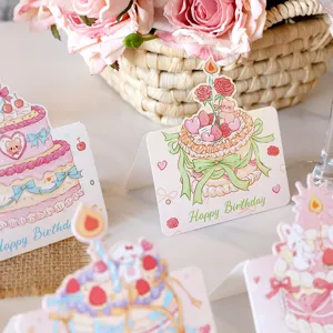 Detailed view of cute cartoon cake illustration on a folded birthday greeting card