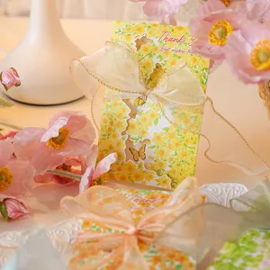 Detailed macro shot of a yellow floral greeting card featuring a delicate golden bow