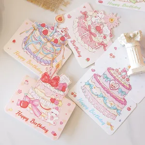 Detailed view of cute birthday cards featuring hand-drawn cake and bear illustrations