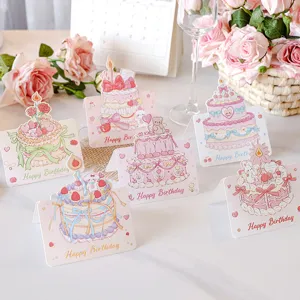 Detailed view of cute birthday cards with colorful cake designs and floral accents