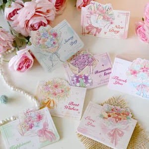 Close-up of 3D bouquet greeting cards with elegant floral patterns and gold lettering.