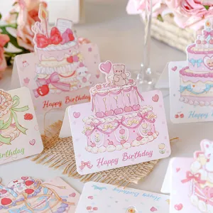 Detailed view of cute cartoon 3D birthday cards featuring cake and bear designs.