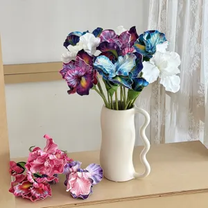 Artistic close-up of colorful oil painting style artificial iris flowers in a wavy ceramic vase