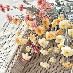 Detailed view of multi-headed flocked camellia artificial silk flowers in pink and yellow