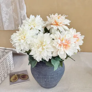 Detail of vintage dahlia artificial flowers with burnt edges in a rustic vase for decor.