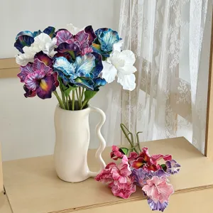 Close-up of vibrant oil-painting style artificial Iris flowers in a ceramic vase