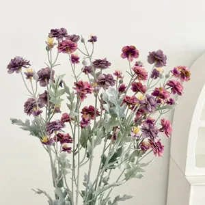 Detailed view of purple flocked artificial camellia flowers with fuzzy green leaves and stems