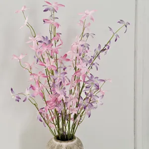 Close-up of pink and purple artificial orchids in a stone vase for home decor
