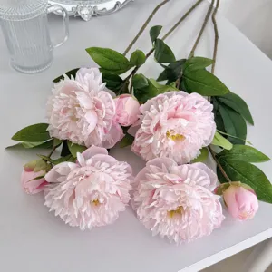 Detailed macro view of pink artificial peony flowers with realistic silk petals and buds.