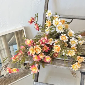 Detailed view of artificial autumn chrysanthemum bouquet on a rustic wooden ladder
