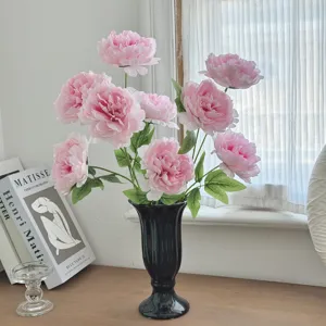 Elegant pink artificial peony bouquet in a black vase for minimalist home decoration