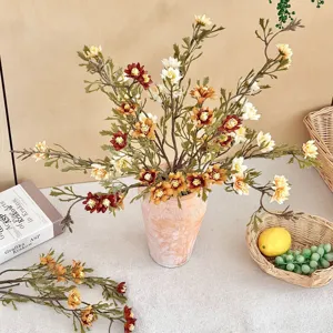 Vintage autumn-colored artificial daisy bouquet in a rustic clay vase for home decor