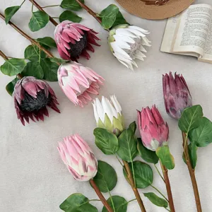 Close-up detail of realistic artificial King Protea buds in assorted colors for home decor