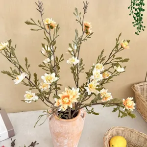 Detailed close-up of vintage autumn-colored faux chrysanthemum bouquet in terracotta vase