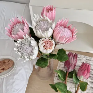 Close-up of realistic artificial King Protea flowers in pink and white for home decor
