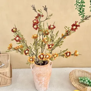 Close-up of autumn-toned artificial wild chrysanthemum in a vintage ceramic vase.
