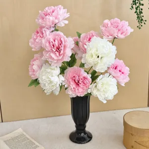 Elegant pink and white artificial silk peonies in a black vase for home decor