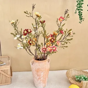 Detailed view of rustic autumn artificial chrysanthemum bouquet in a terracotta vase centerpiece