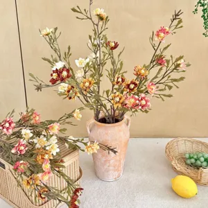 Detail of realistic autumn-colored artificial daisy bouquet in a rustic vase for home decor