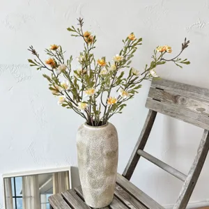 Vintage faux wild chrysanthemum bouquet in textured ceramic vase for autumn home decoration