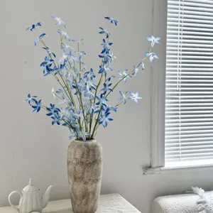 Vibrant blue artificial Oncidium orchids in a rustic textured ceramic vase for home decor