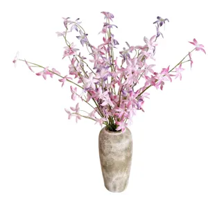 Realistic pink artificial Oncidium orchids in textured ceramic vase for home decor.