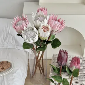 Elegant artificial King Protea flower arrangement in glass vase for home decor
